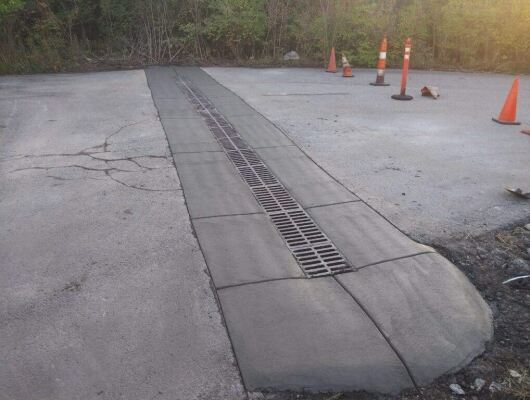 Parking lot drainage grate